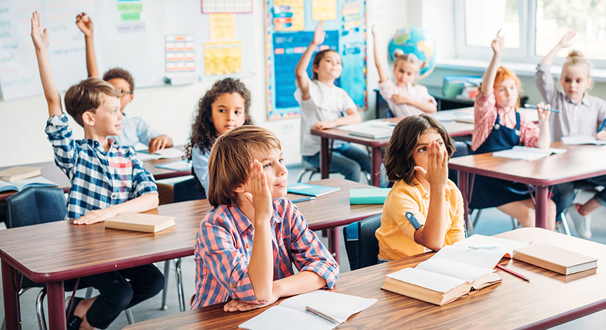 kids raising hands in class